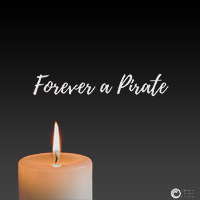 Single candle over a black field with the words pirate for life.