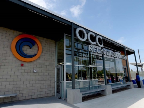 Building with brick facade and glass, the OCC logo and the signage OCC Recycling Center