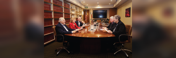Board of Trustees gathered around a conference table in conversation