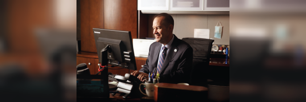 Chancellor Weispfenning at his desk typing