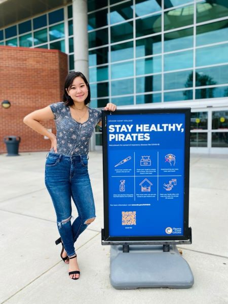 Yuna Watanabe with a Stay Healthy Pirates sign