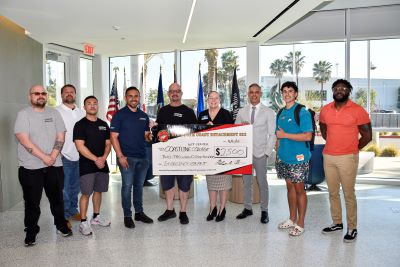 Coastline VRC receiving a check from the Marine Corps League South Coast Detachment 022